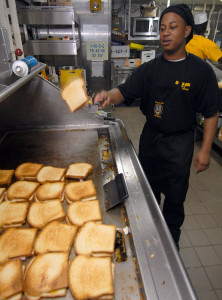 US_Navy_060822-N-4856C-052_Culinary_Specialist_3rd_Class_James_M._Freeman_prepares_grilled_ham_and_cheese_sandwiches_in_the_chief_petty_officers_galley_aboard_the_amphibious_assault_ship_USS_Iwo_Jima_(LHD_7)