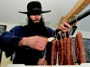 UNITY,  ME-  January 13: Matt Secich hangs sausages on a bar to dry at his Charcuterie shop in Unity on Wednesday, January 13, 2016. (Photo by David Leaming/Staff Photographer)